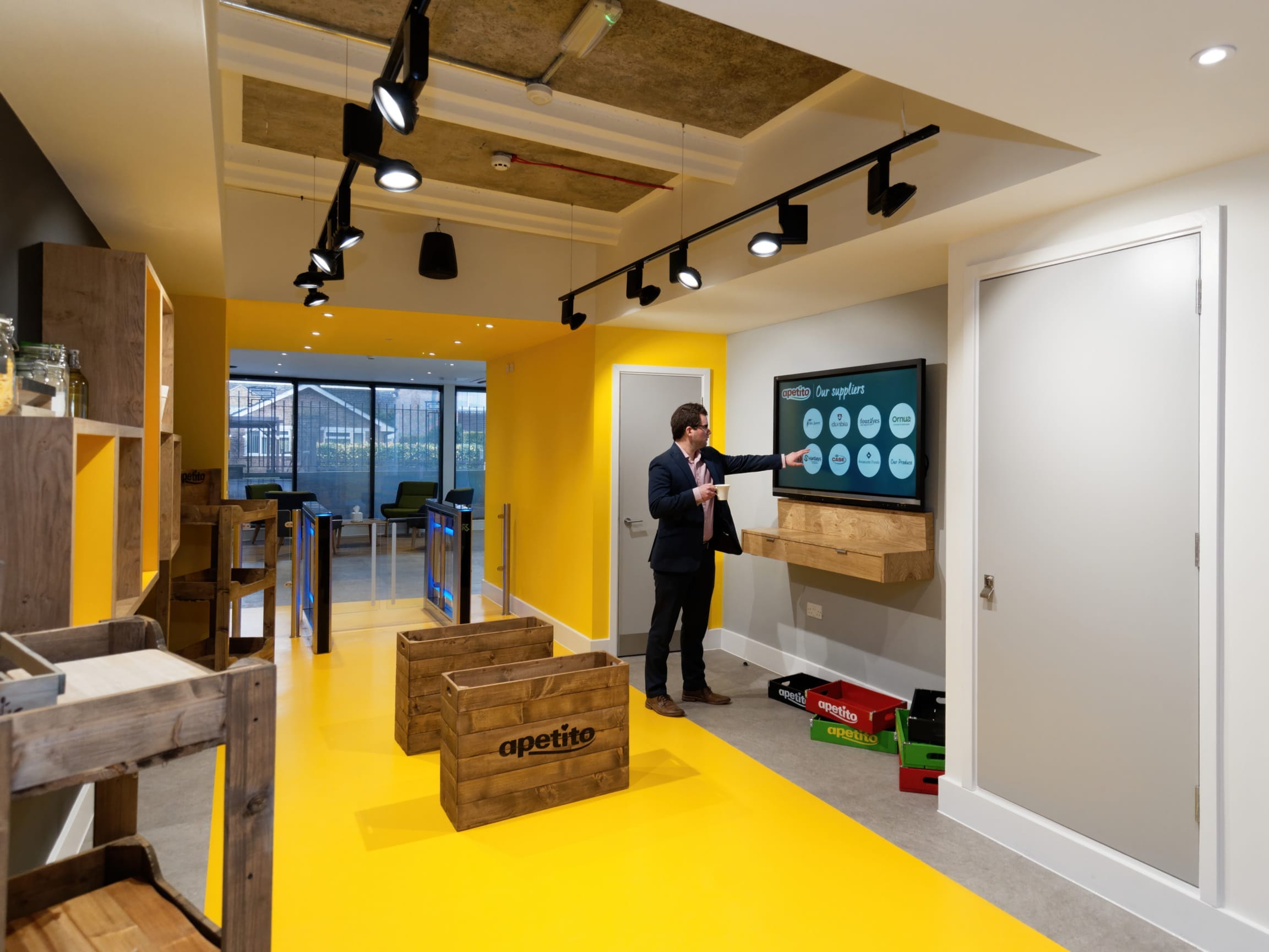 Modern apetito meeting room with long timber table, library shelving and contemporary seating