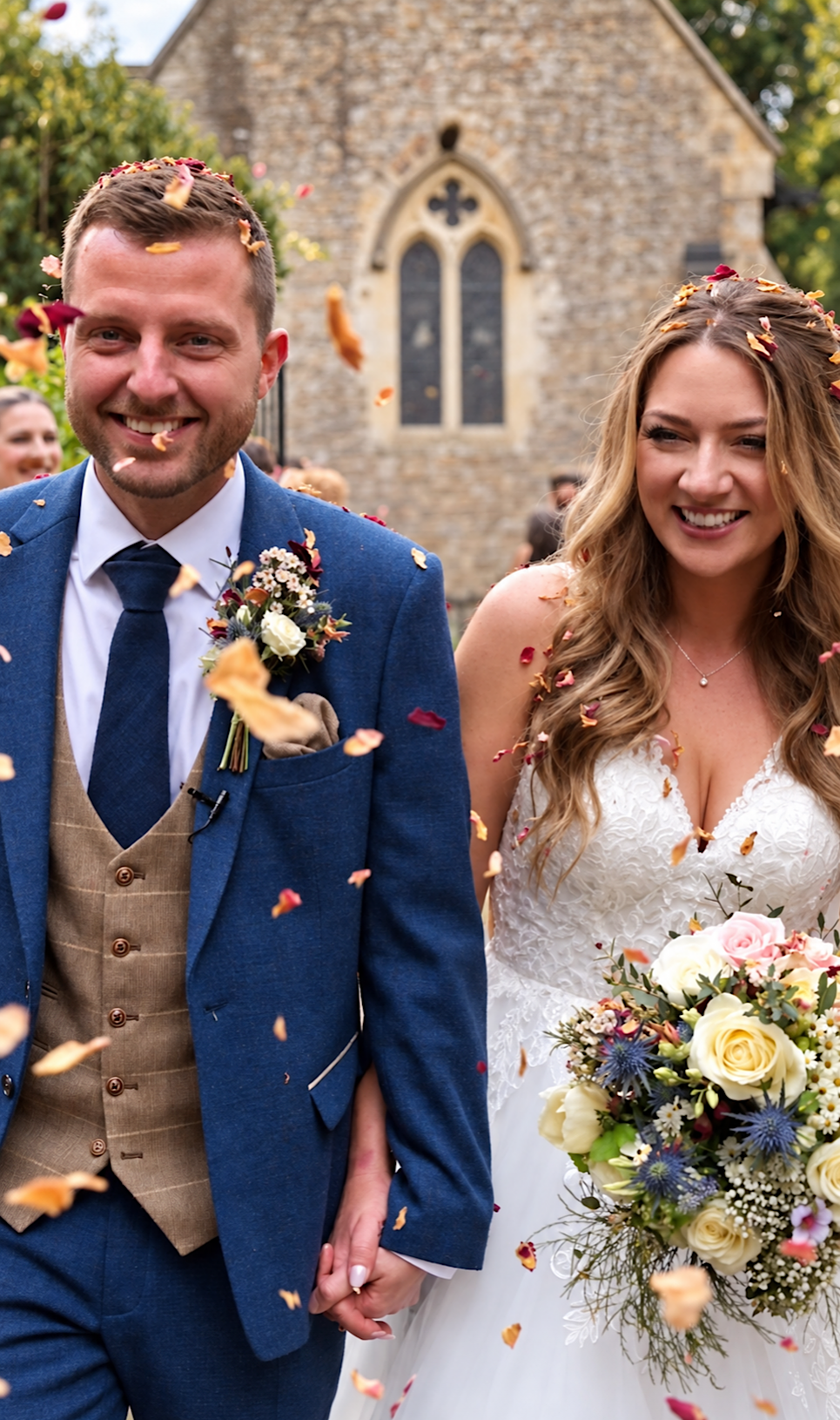 Jess and Cal walking through confetti outside the church at Orchardleigh