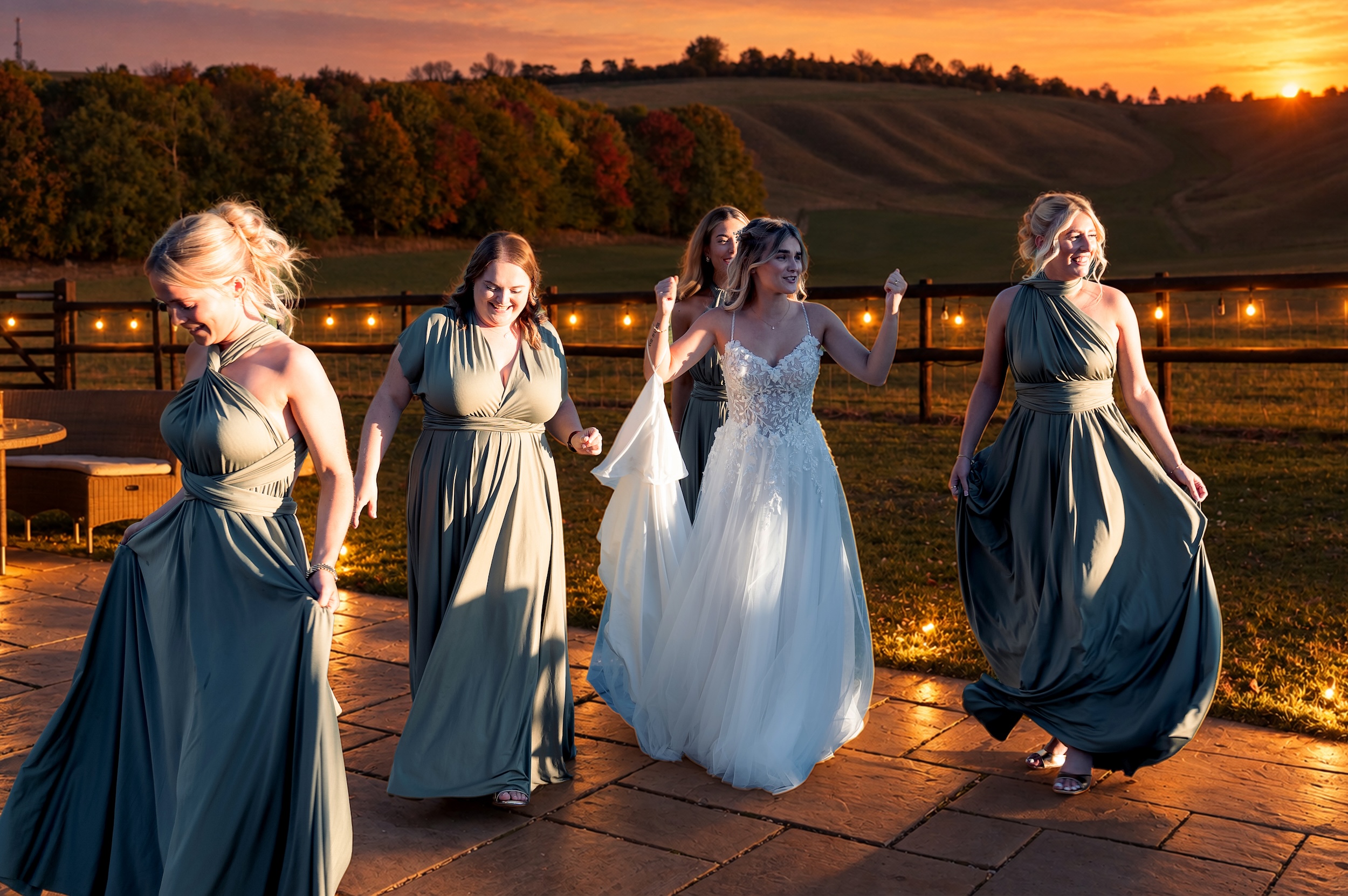 Ella celebrating with her bridesmaids at sunset during her Wellington Barn wedding reception